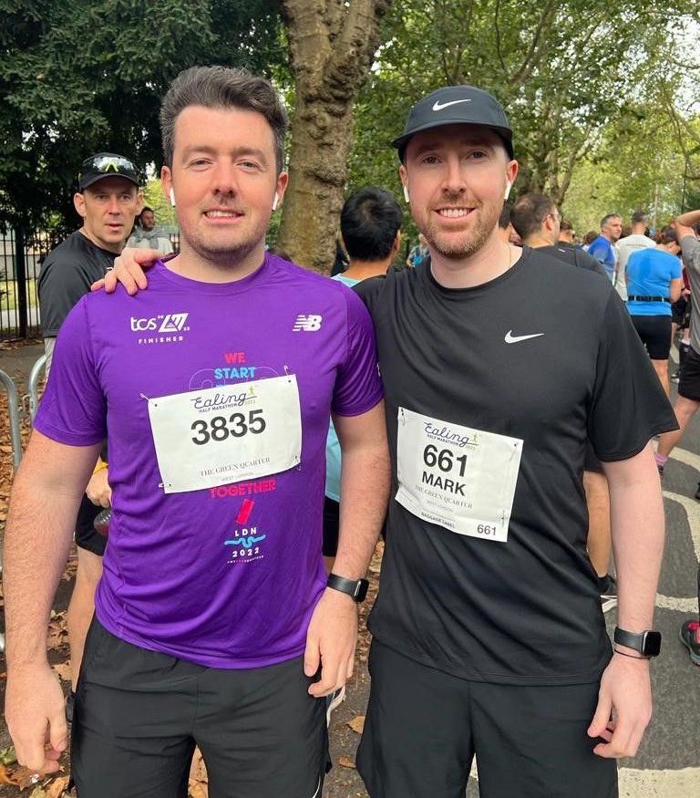 Mike and Mark after running the half marathon, stood for a picture