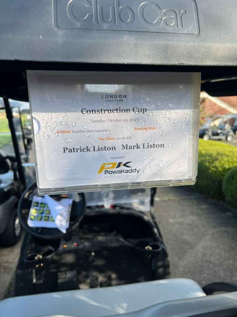 A poster on the back of a golf cart at a charity golf day