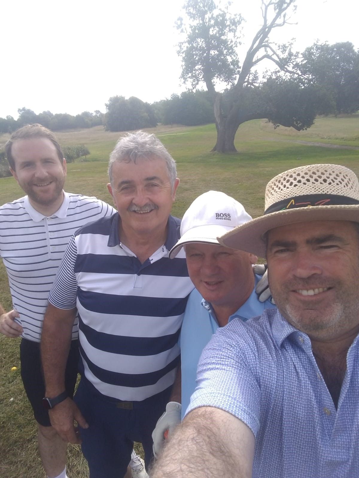 A selfie of four men from a charity golf day